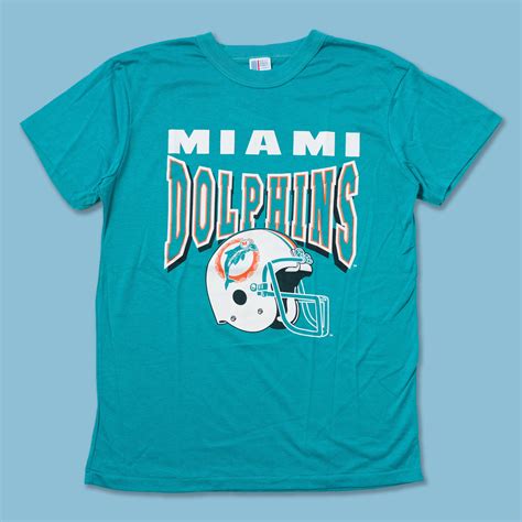 Are you a fan of the Miami Dolphins and looking for some vintage style shirts to show your support? Browse through the wide selection of vintage Miami Dolphins shirts on Amazon.com and find your favorite design, color, and size. Whether you want a classic logo, a retro graphic, or a throwback jersey, you'll find it here at a great price. Don't miss this …
